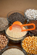 brown and white beans in clear glass bowls