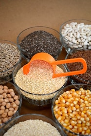 brown and white beans in clear glass bowls