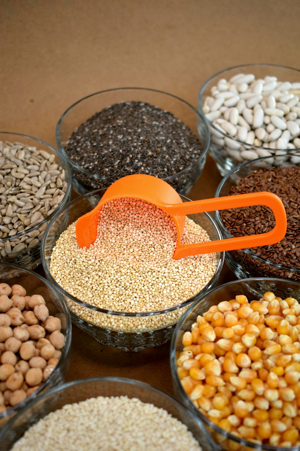 brown and white beans in clear glass bowls