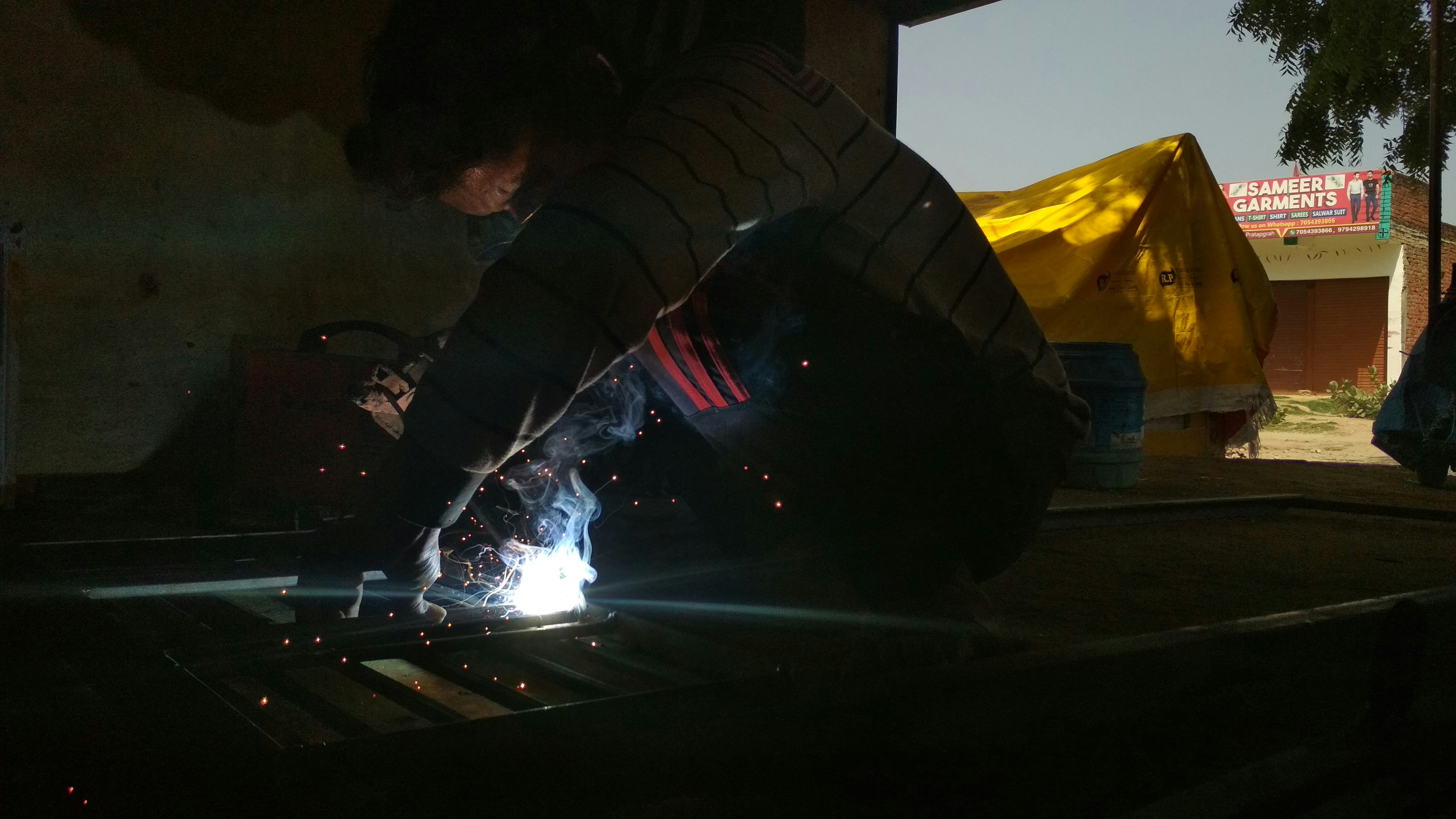 Closeup of several electric vehicle brand logos on grilles, illustrating different auto brands competing in the EV market