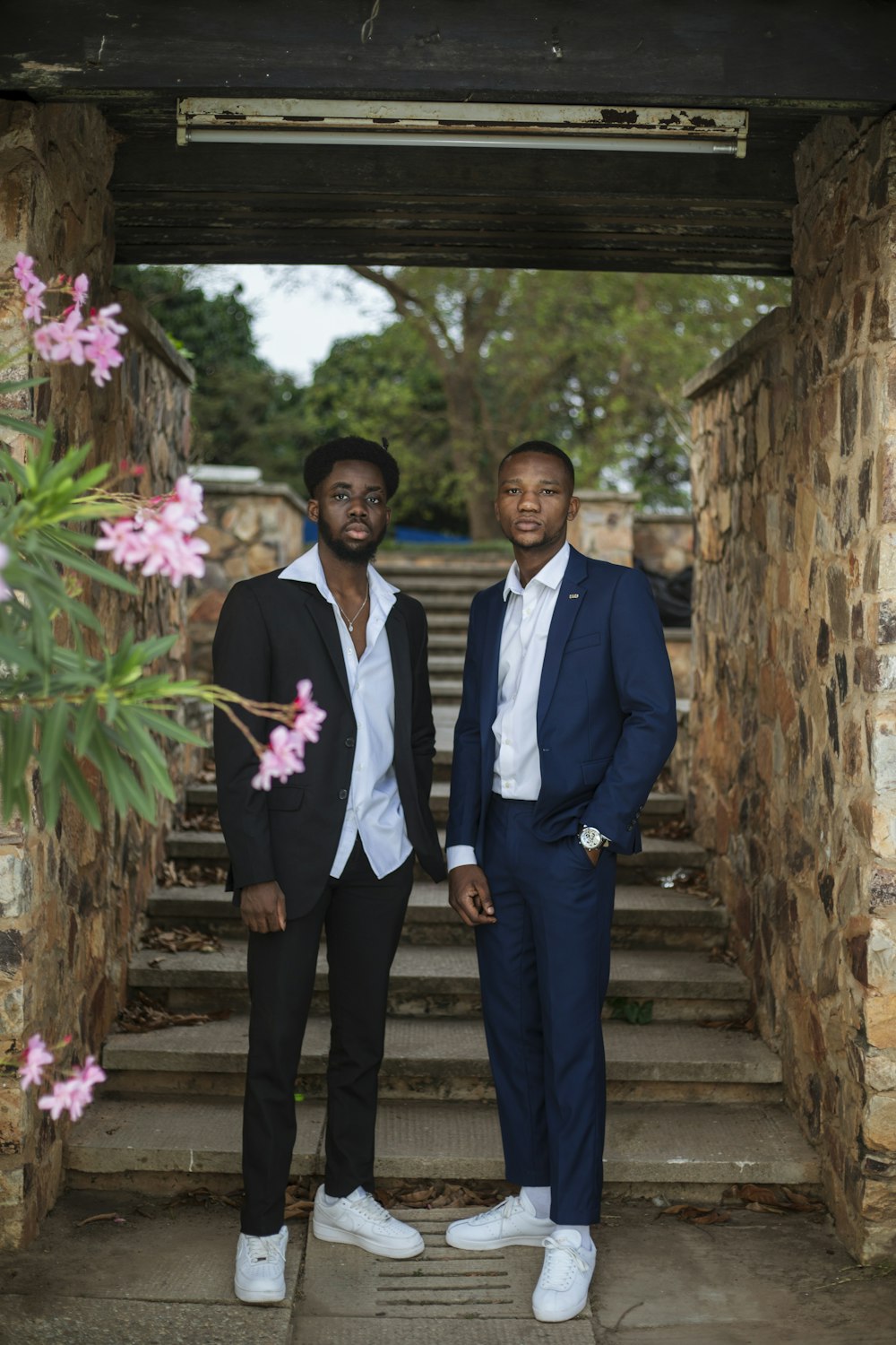 man in black suit standing beside man in black suit jacket