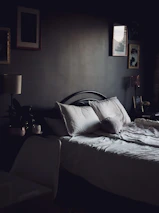 A cozy bedroom with plush bedding and warm, inviting lighting.