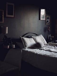 A cozy bedroom featuring a comfortable bed and soft lighting.
