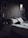 A cozy bedroom with a neatly made bed featuring decorative pillows.