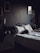 Cozy hotel room with a neatly made bed and warm lighting.