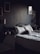 Cozy bedroom with soft lighting and gold accents, designed for restful short-term stays.