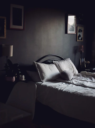 A cozy bedroom featuring a comfortable mattress with soft bedding.