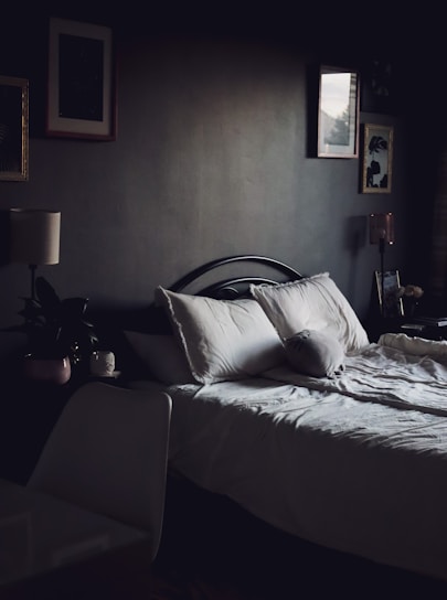 A cozy and inviting bedroom with soft lighting and comfortable bedding.