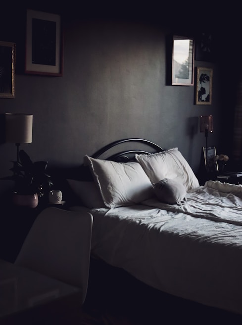 A cozy bedroom featuring a comfortable bed and soft lighting.