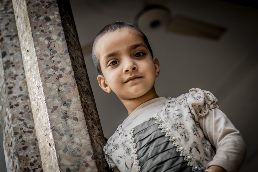 boy in white and black floral dress