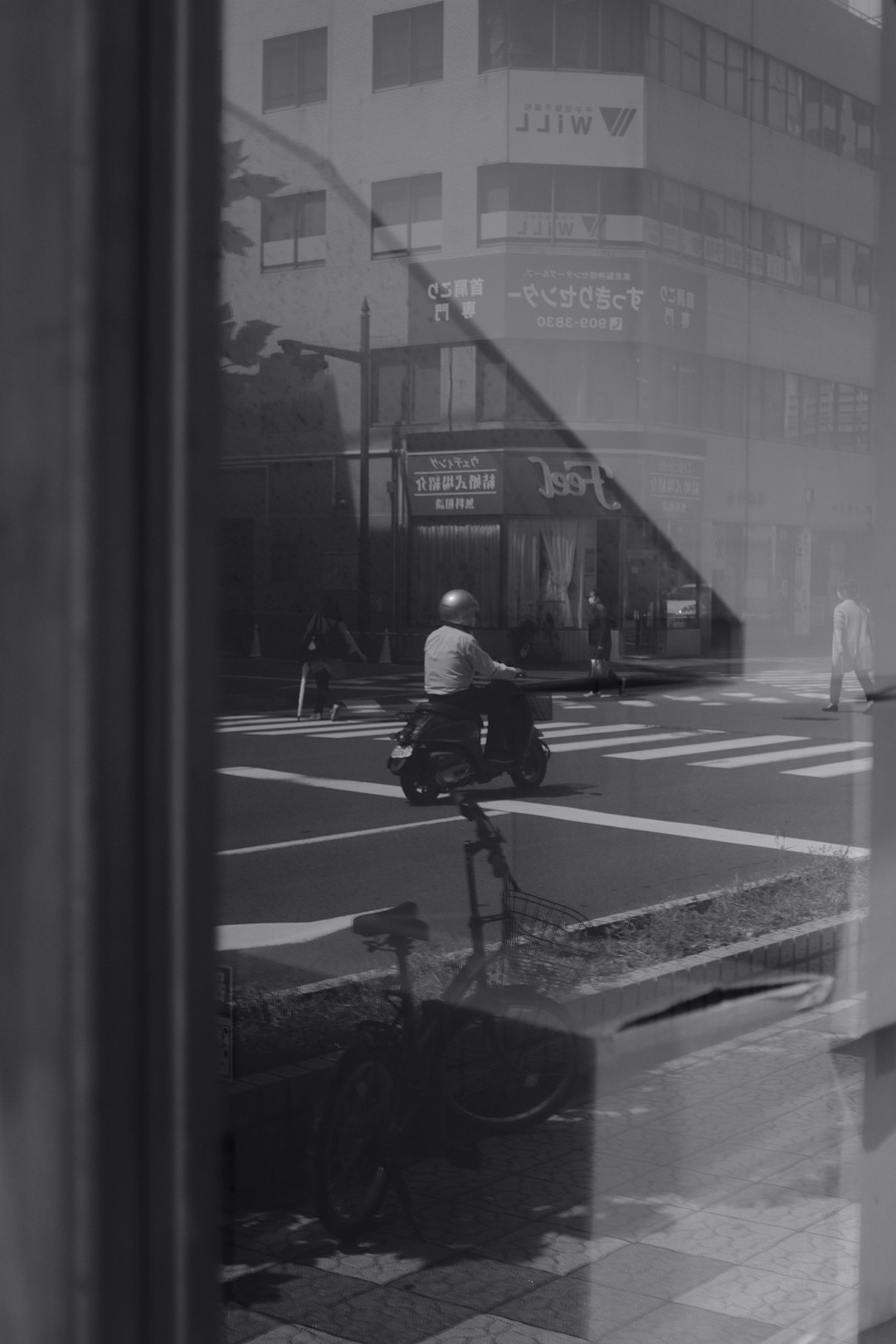 man in white shirt riding bicycle in grayscale photography