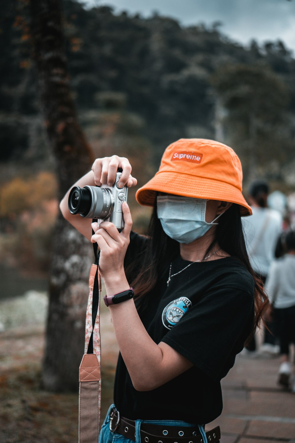 woman in black shirt holding black and silver camera