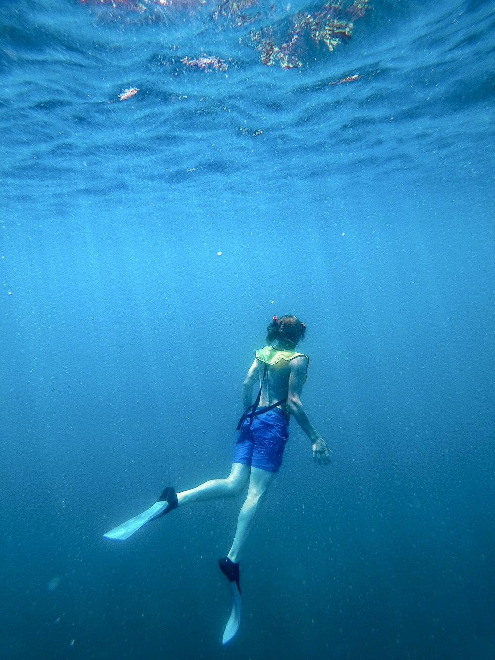 a man swimming in the ocean with his feet in the water