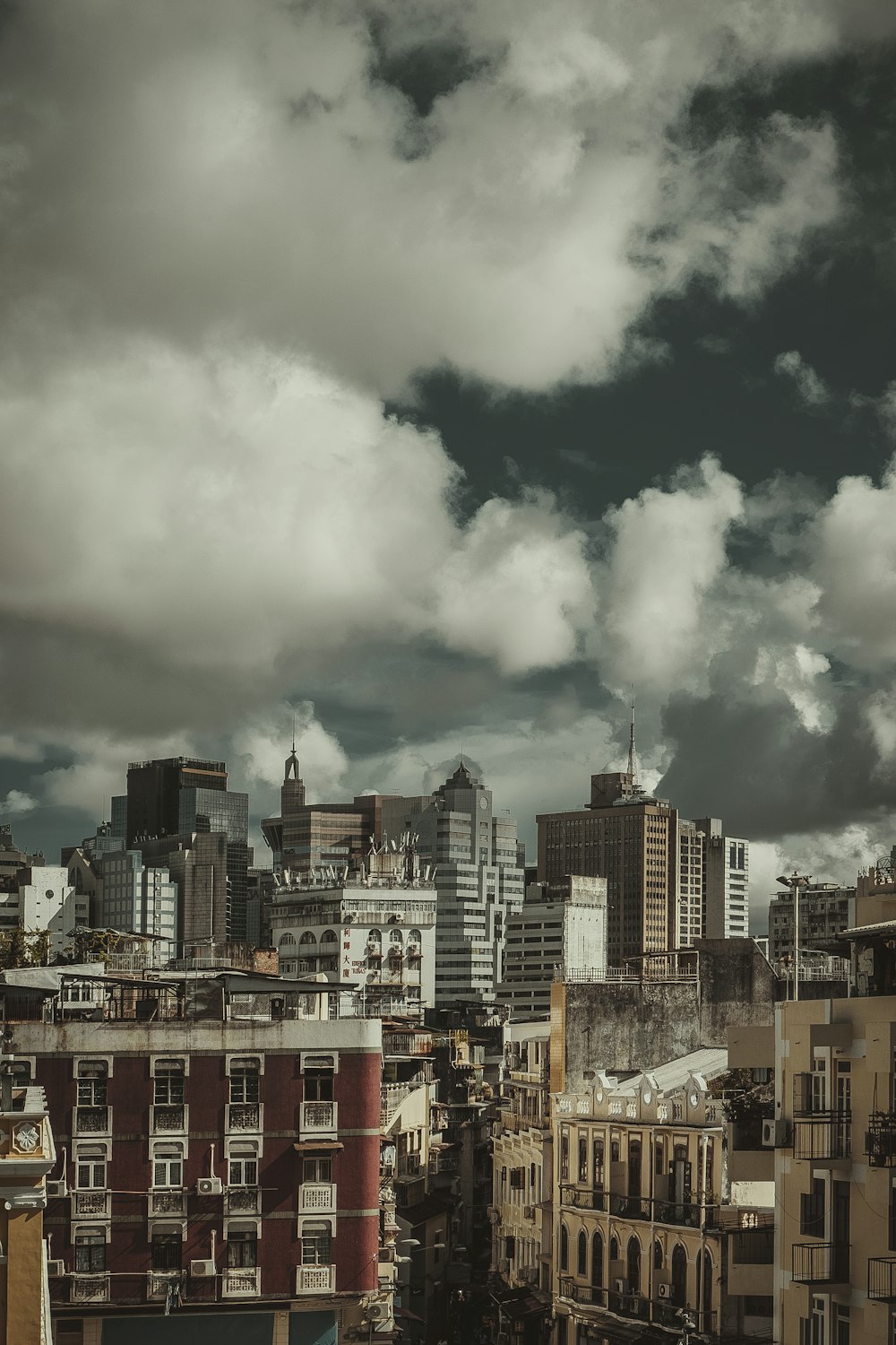 city buildings under white clouds during daytime