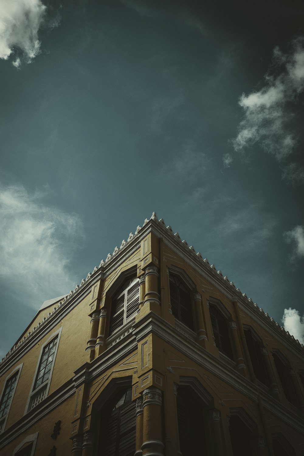 brown concrete building under blue sky during daytime