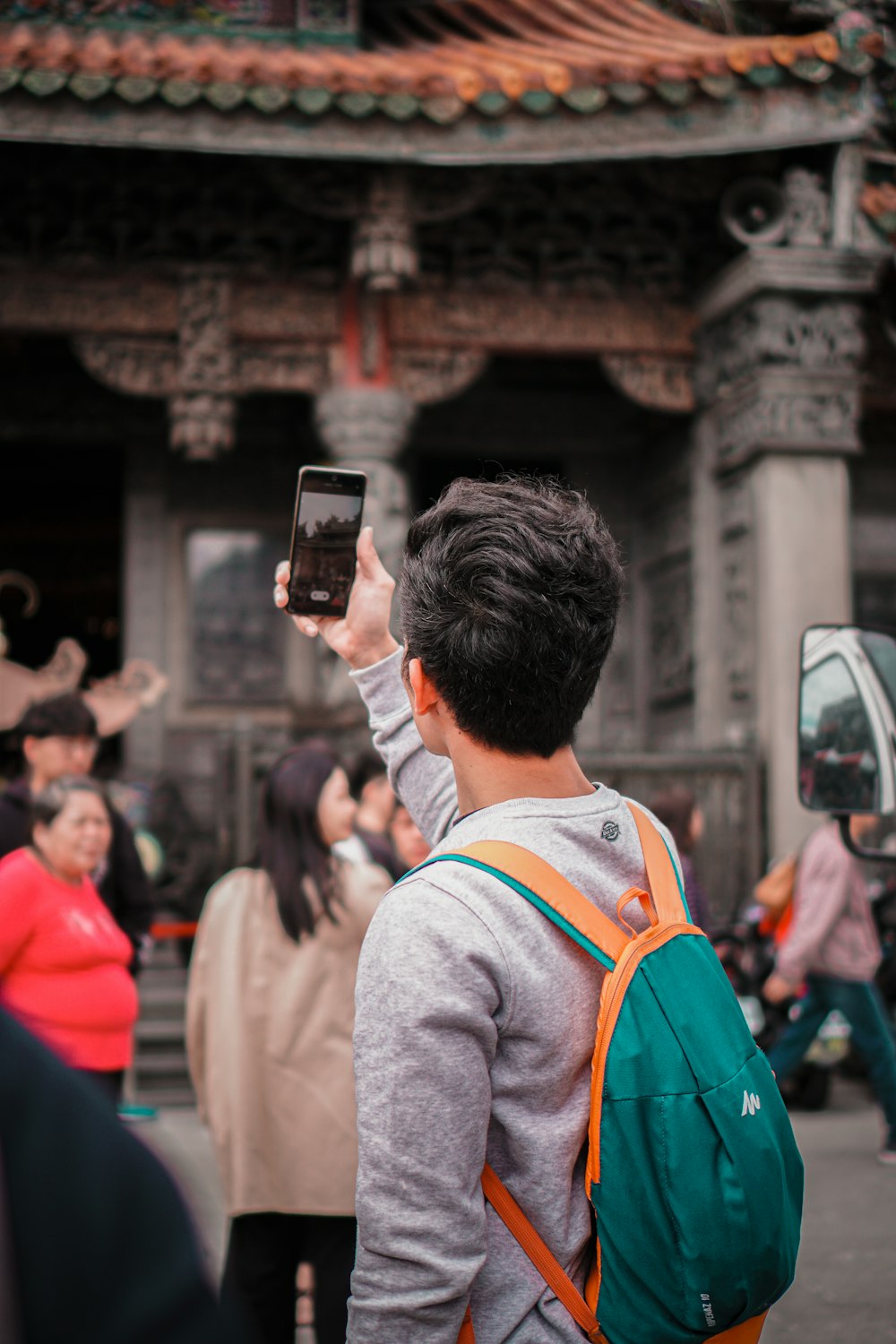man in white long sleeve shirt holding smartphone