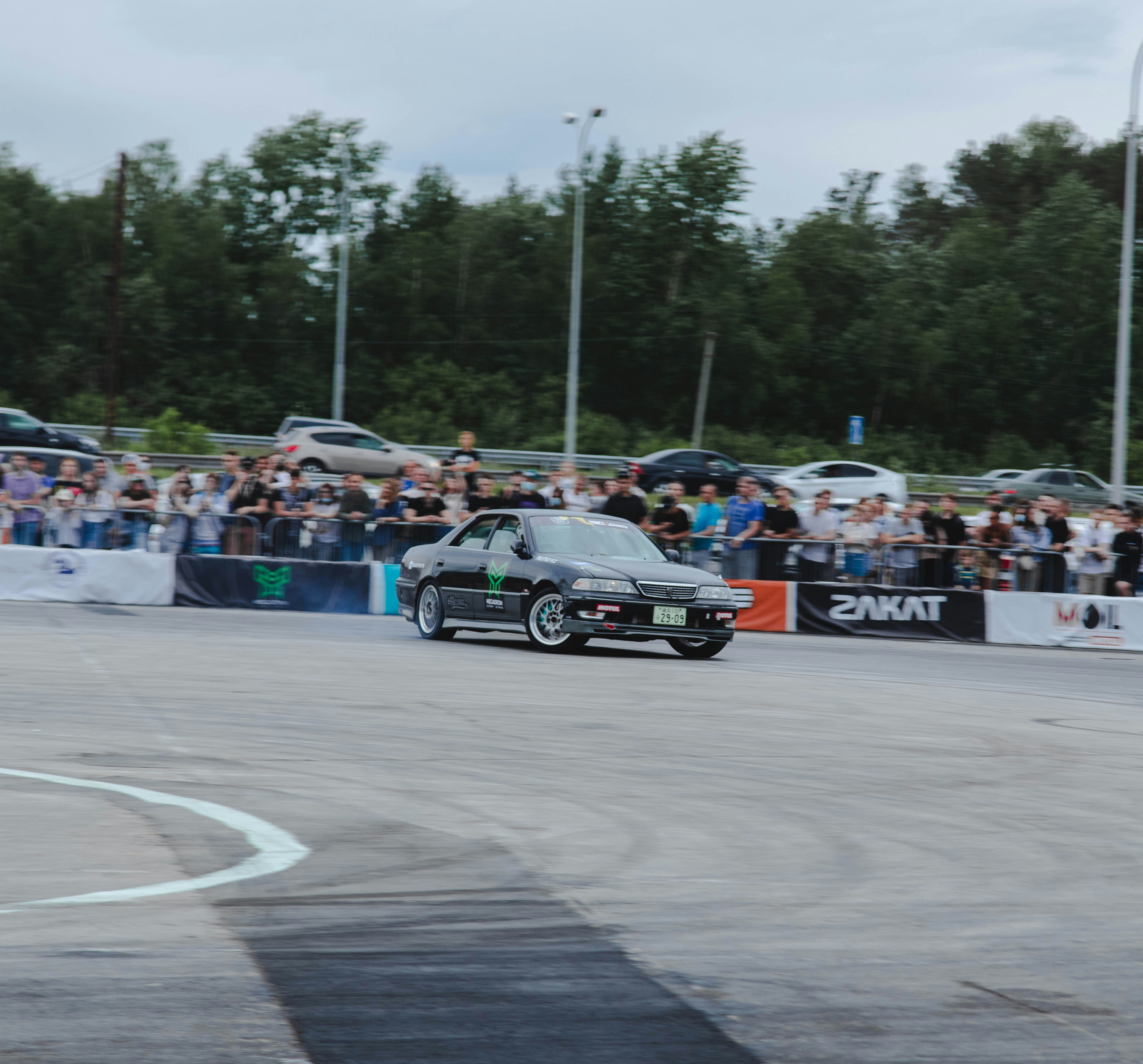 green and black car on track during daytime