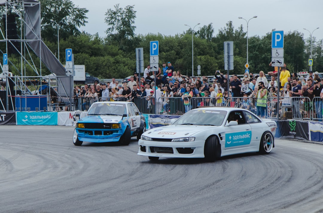 white and blue chevrolet camaro on road during daytime