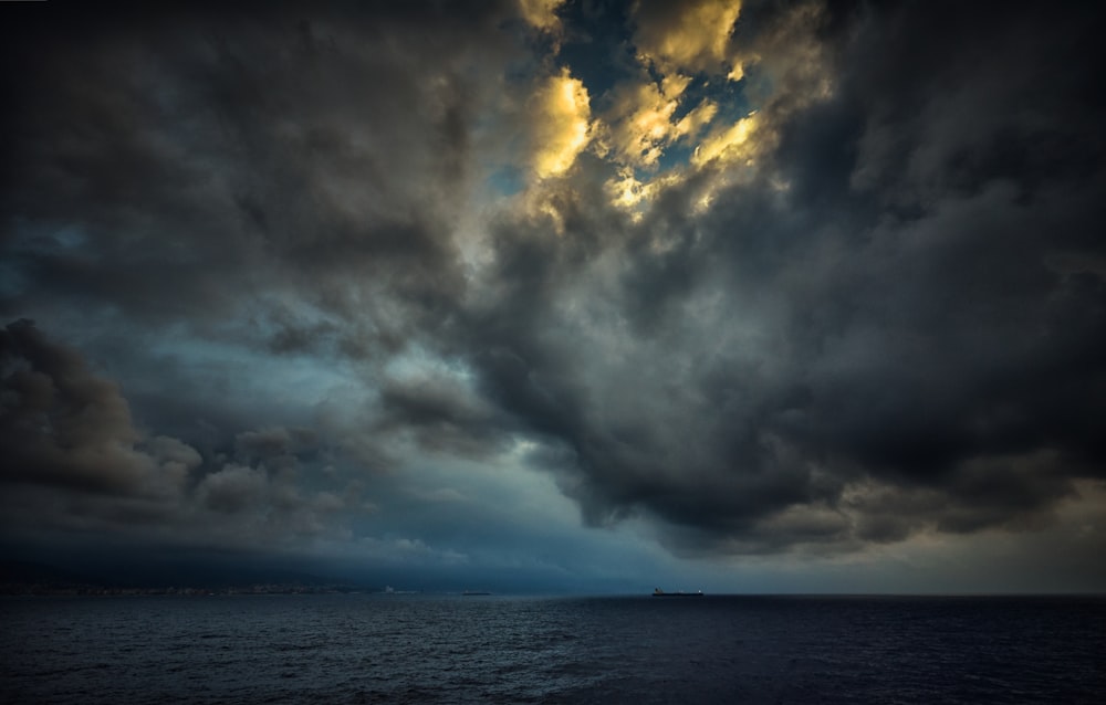 body of water under cloudy sky during daytime