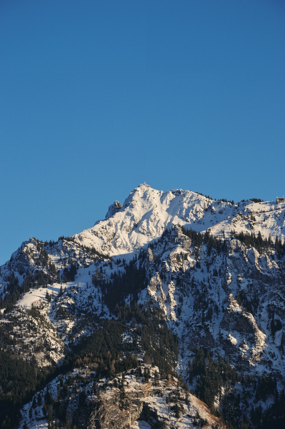 snow covered mountain under blue sky during daytime