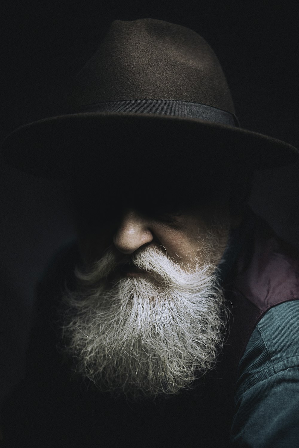 man in black hat and purple shirt