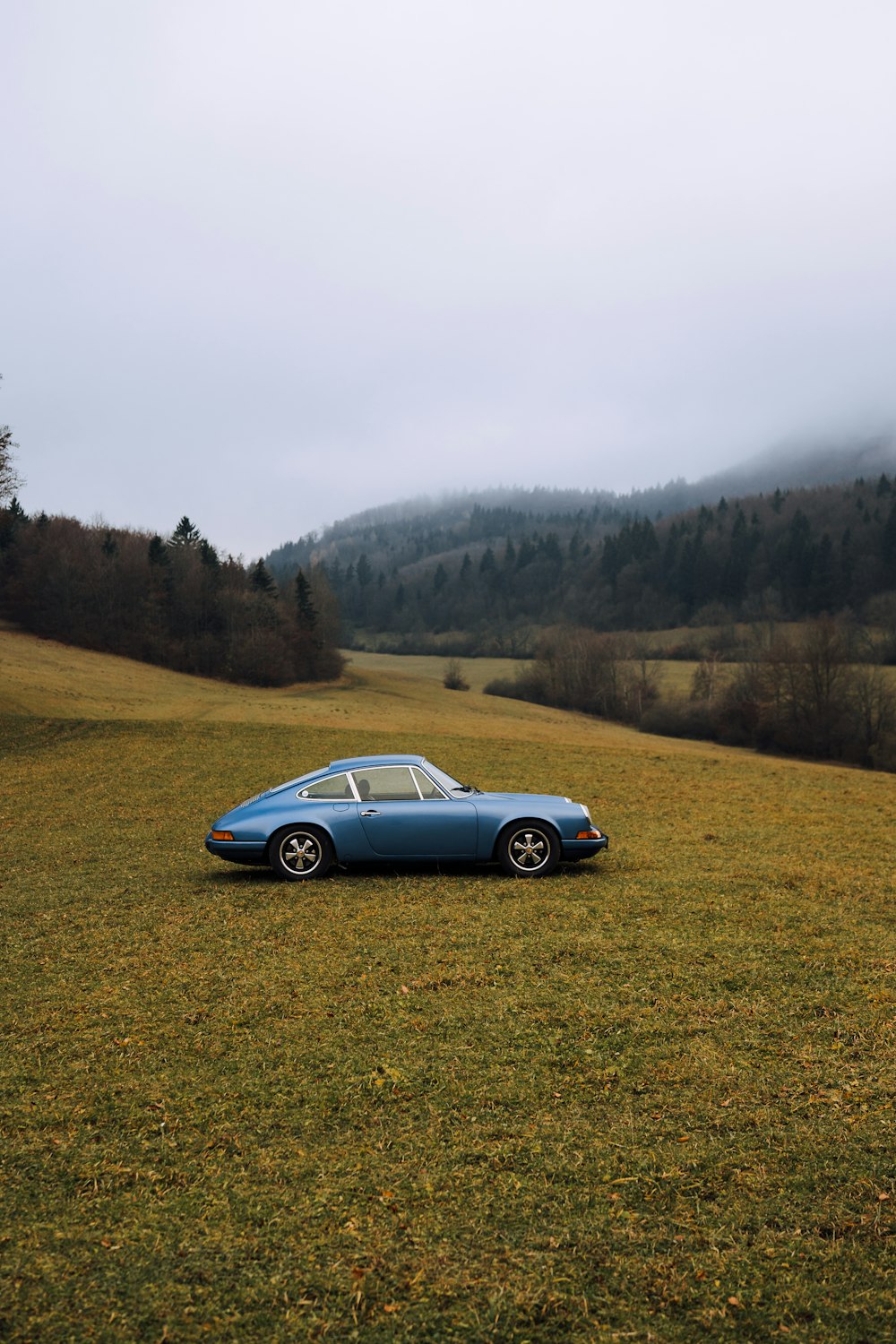 Blaues Coupé tagsüber unterwegs