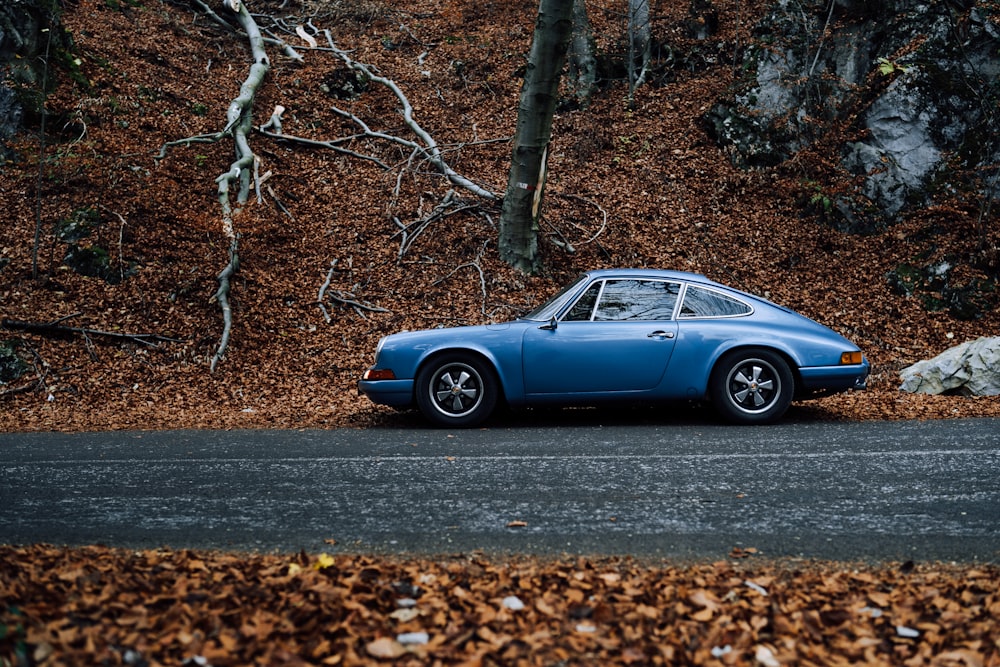 blue coupe parked on road