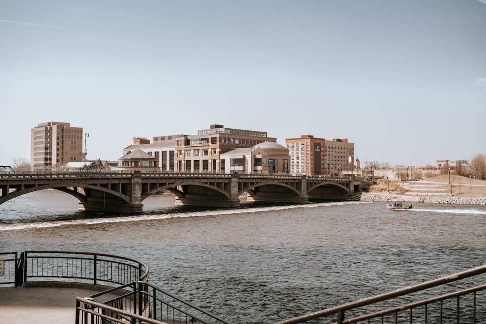 white and brown concrete bridge over river during daytime