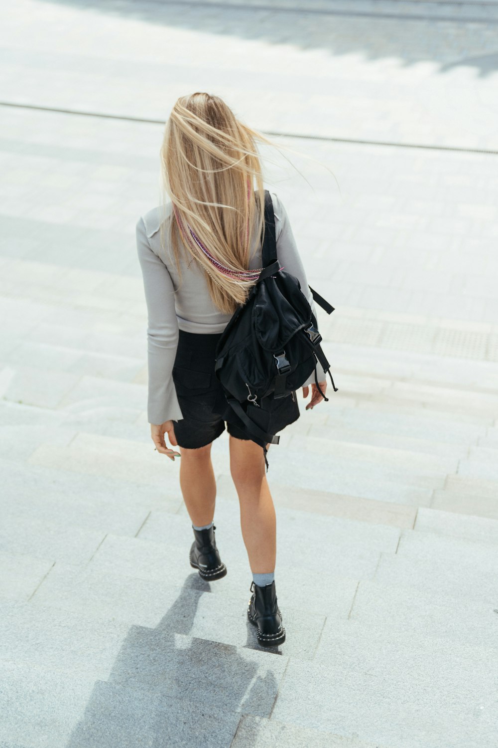 woman in black leather jacket and white skirt