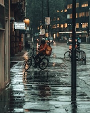 person in black jacket riding bicycle on sidewalk during daytime