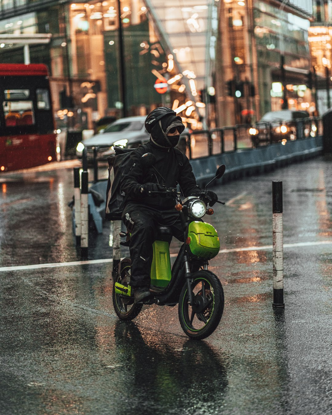 man in black jacket riding green motorcycle