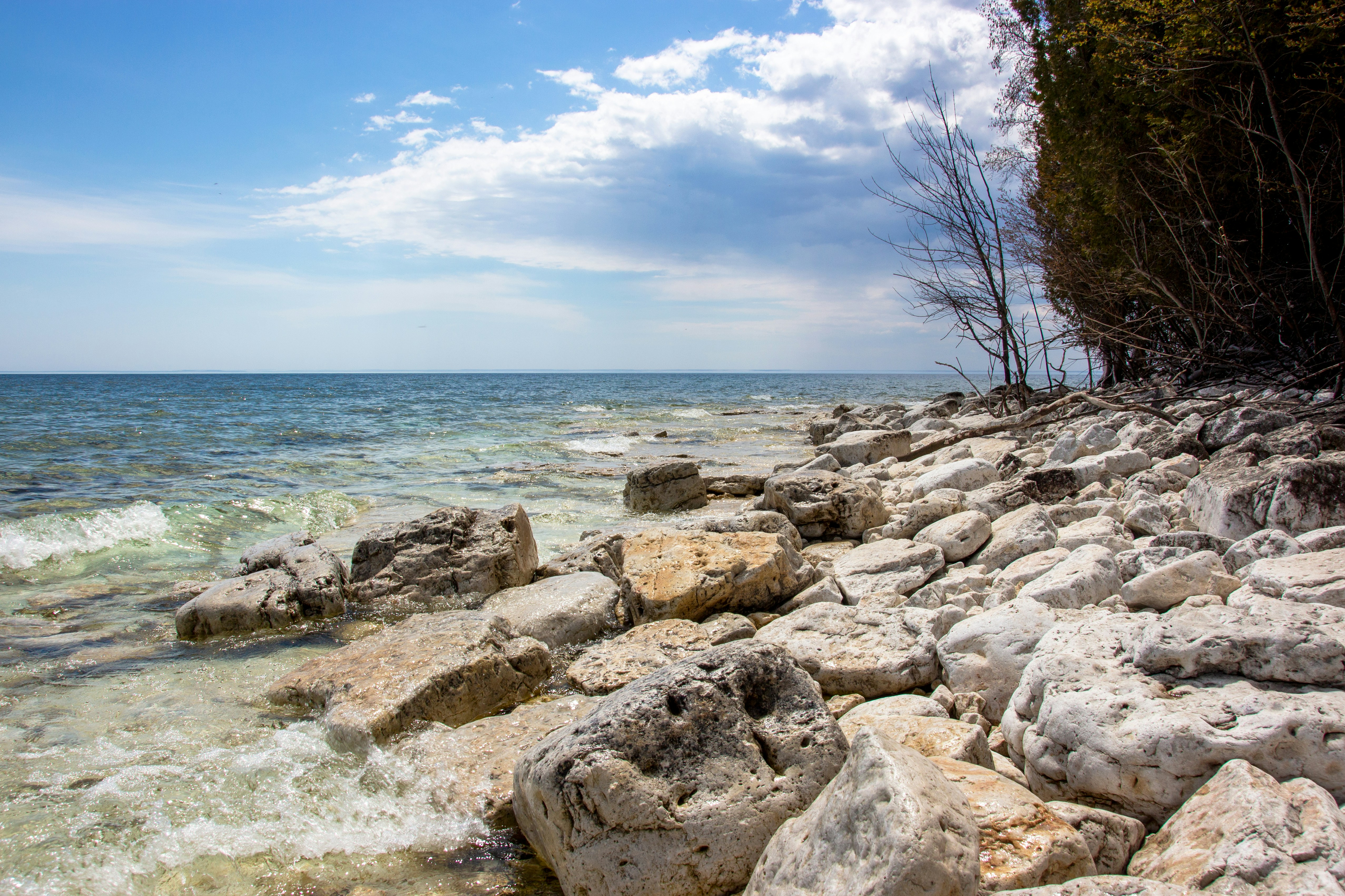 brown rocks near body of water during daytime