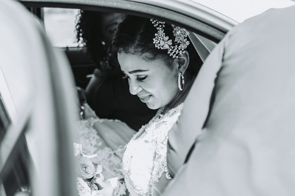 woman in white floral dress sitting on car seat