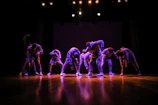 Advanced students performing a synchronized routine on a polished wooden floor.