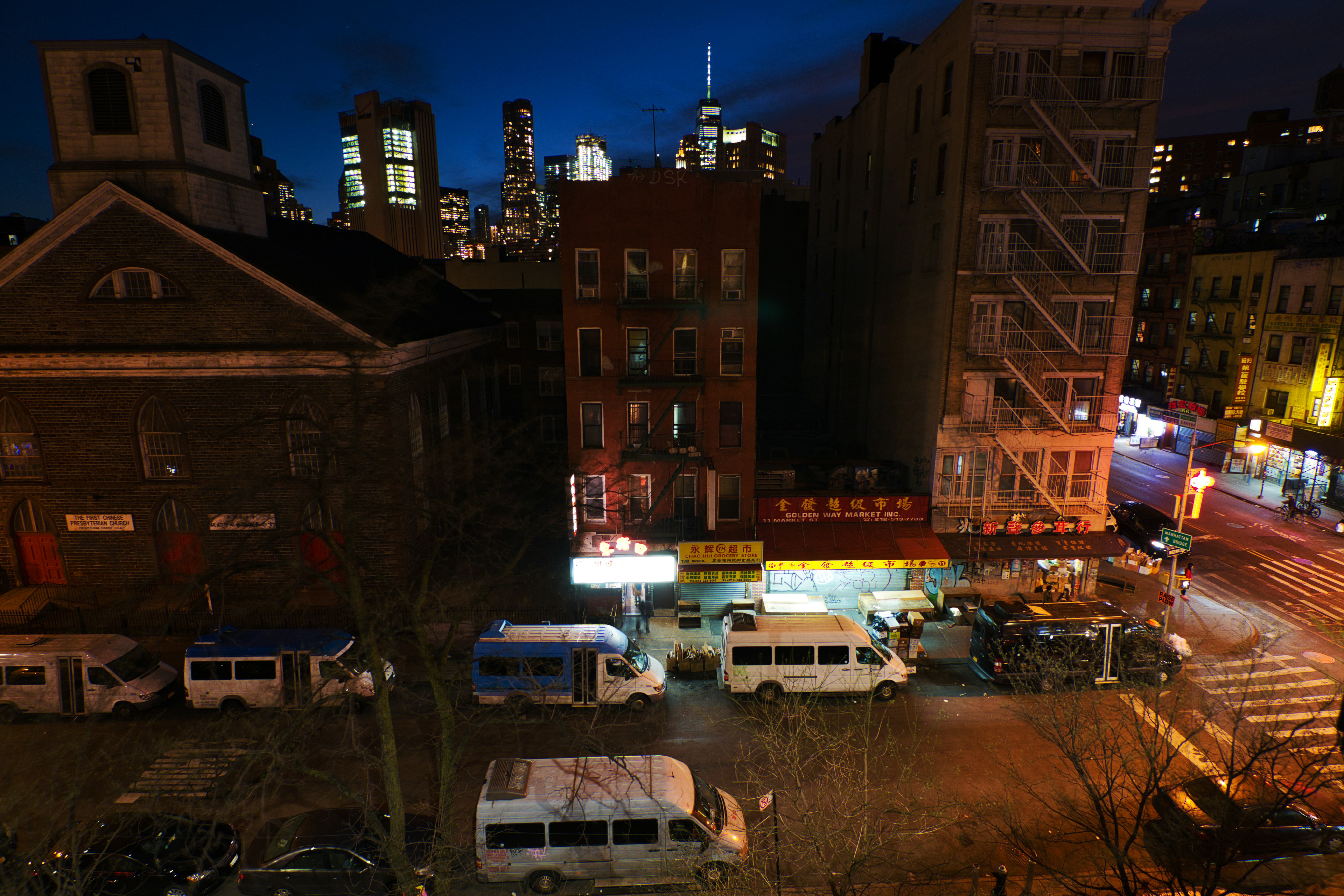Luxury cars outside brownstone at night