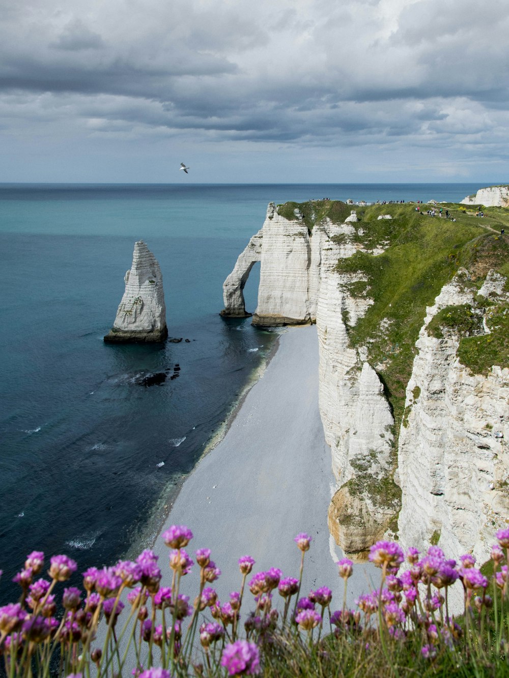 white and brown rock formation on body of water during daytime