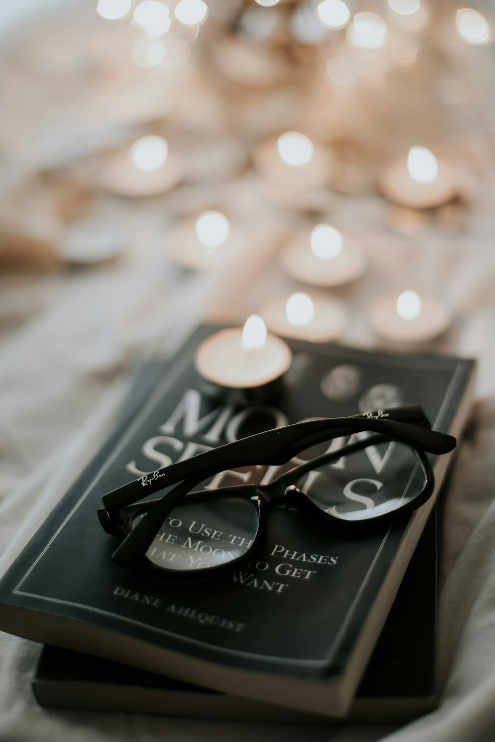 black framed eyeglasses on black and white book