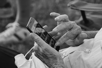 grayscale photo of person holding iphone 6