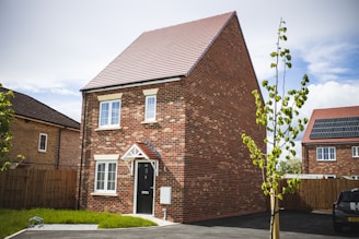 brown brick building near green grass field during daytime