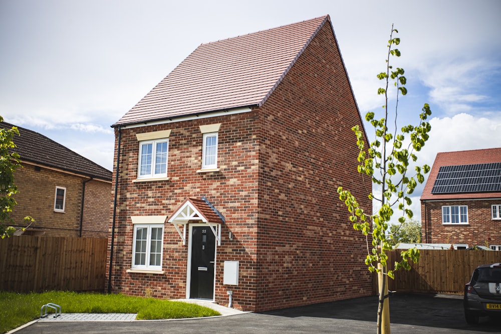 brown brick building near green grass field during daytime