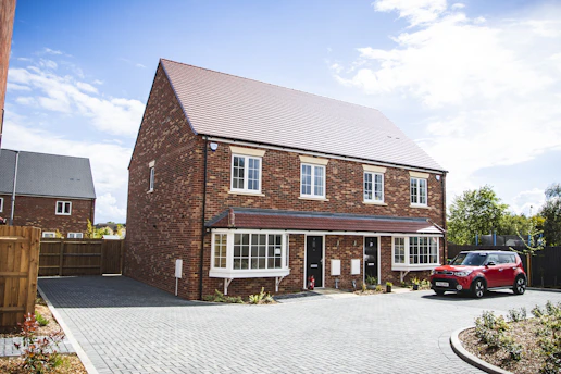 brown brick house under blue sky during daytime