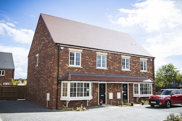 brown brick house under blue sky during daytime
