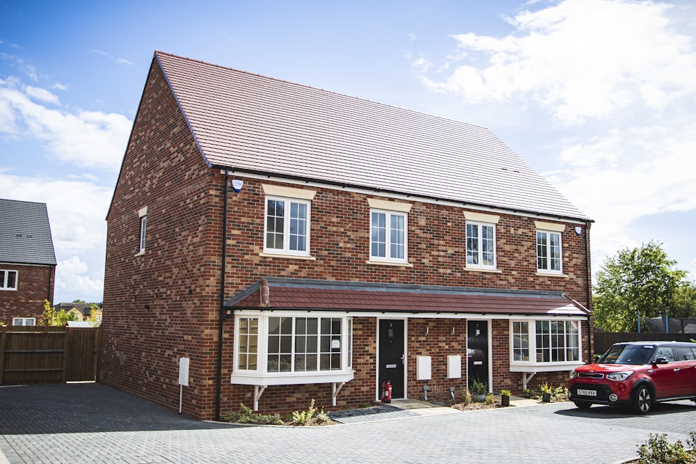 brown brick house under blue sky during daytime