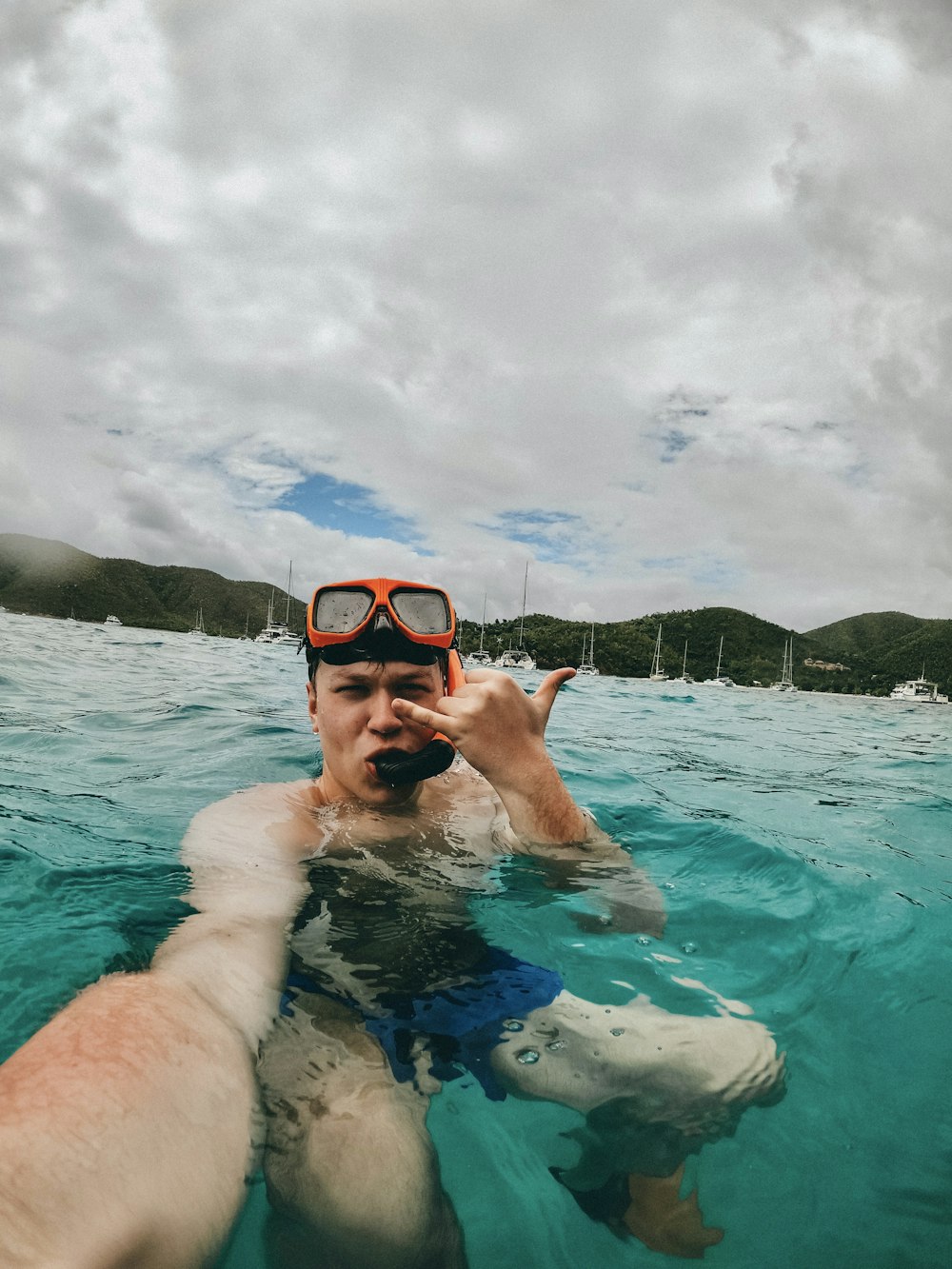 man in blue swimming goggles in water