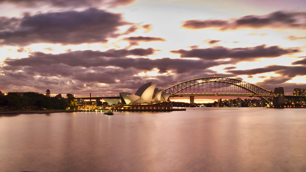 Sydney Opera House under a cloudy sky from a nearby harbour lawn