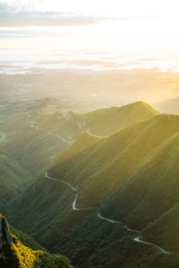 green mountains under white clouds during daytime