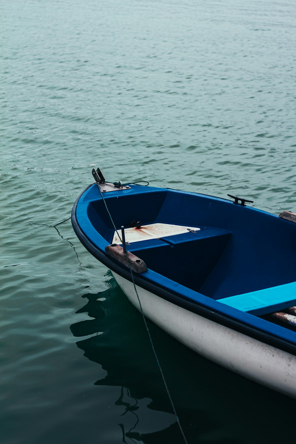 blue and white boat on water during daytime