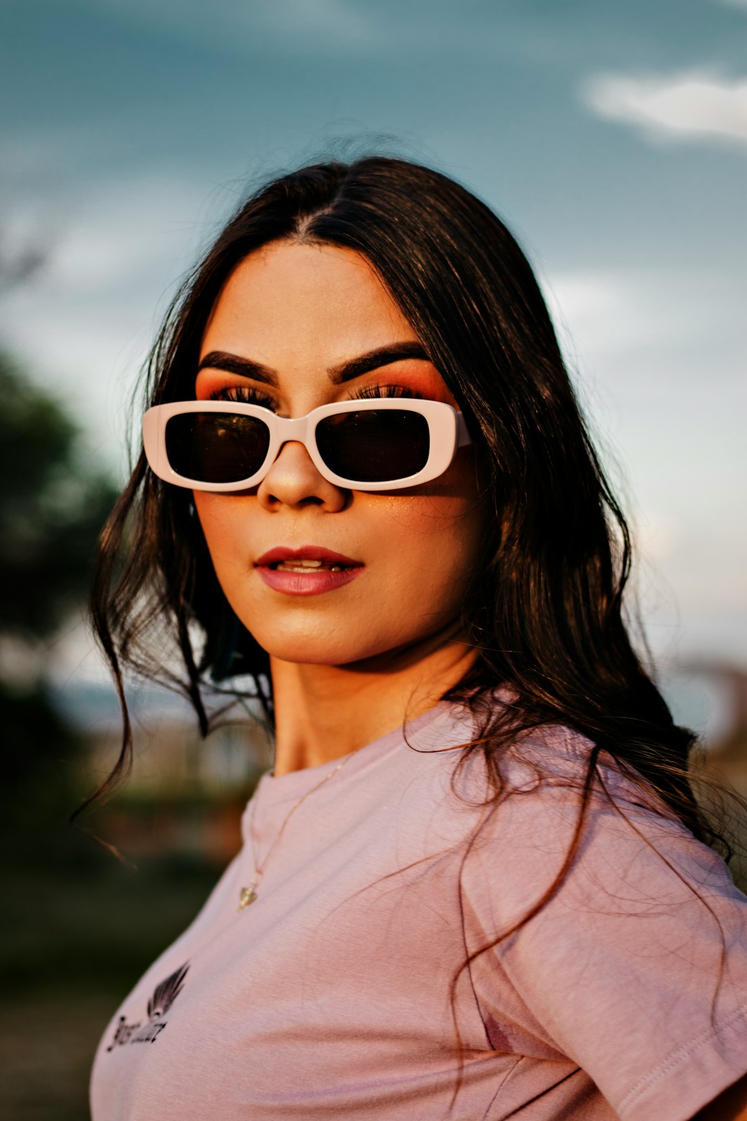 woman in white crew neck shirt wearing brown sunglasses