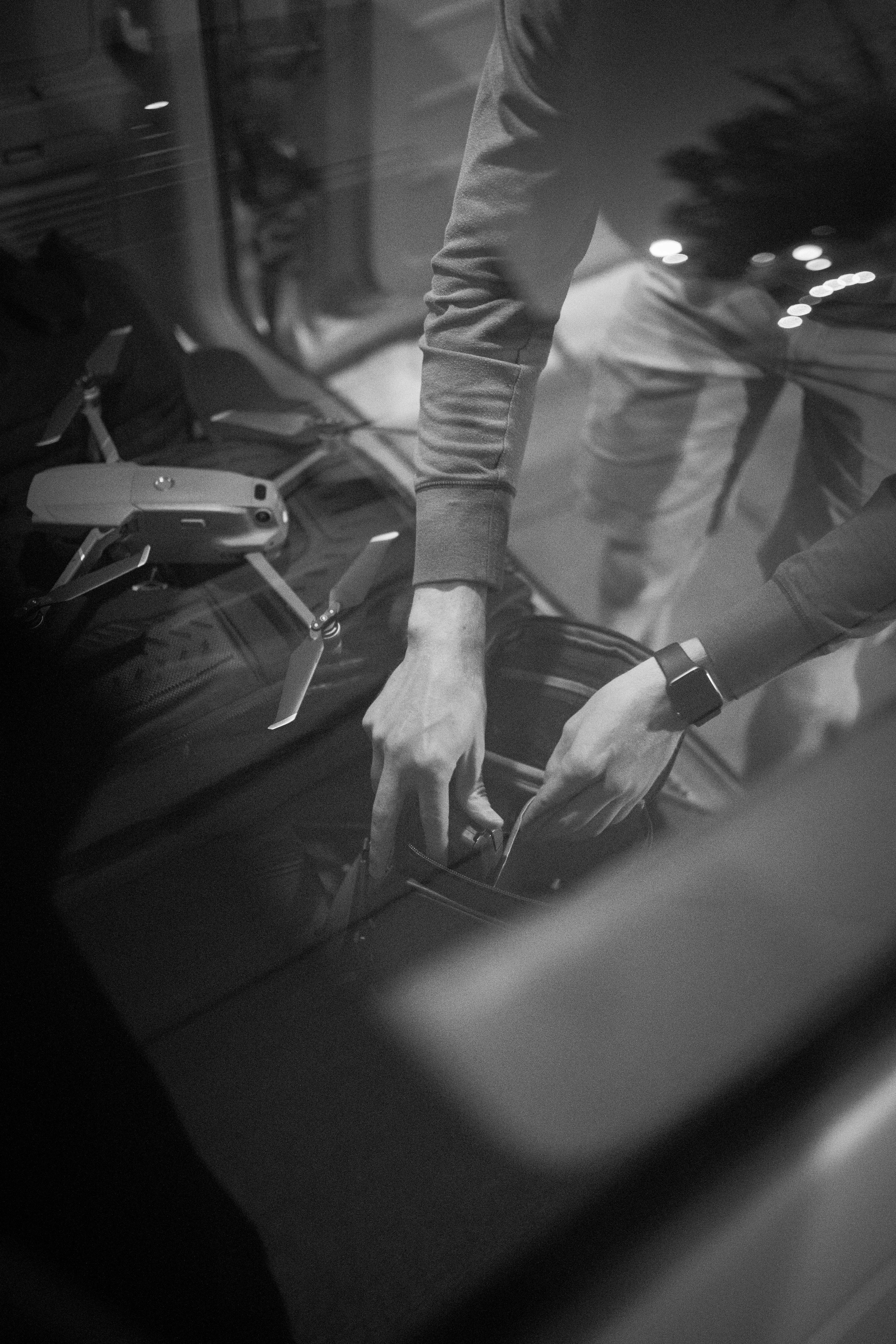 Person gets ready to capture footage with their drone, while choosing the best songs for slow motion video.