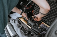 A technician carefully installing a state-of-the-art car alarm system inside a vehicle.